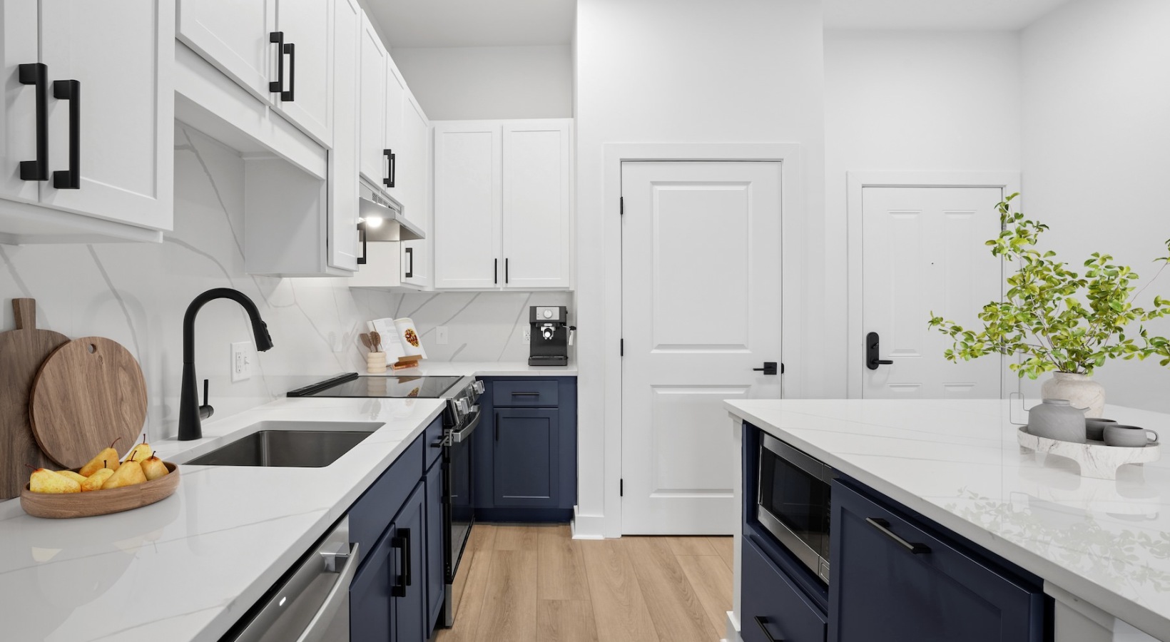a kitchen with white cabinets